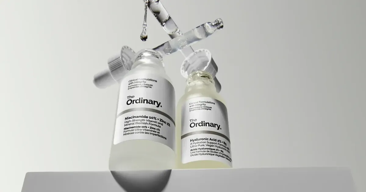 Official serum bottles on a studio field — not a marketplace tile
