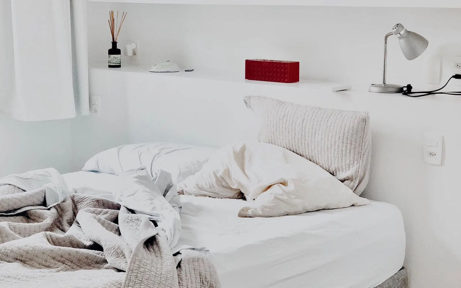 White sheets folded on a bed