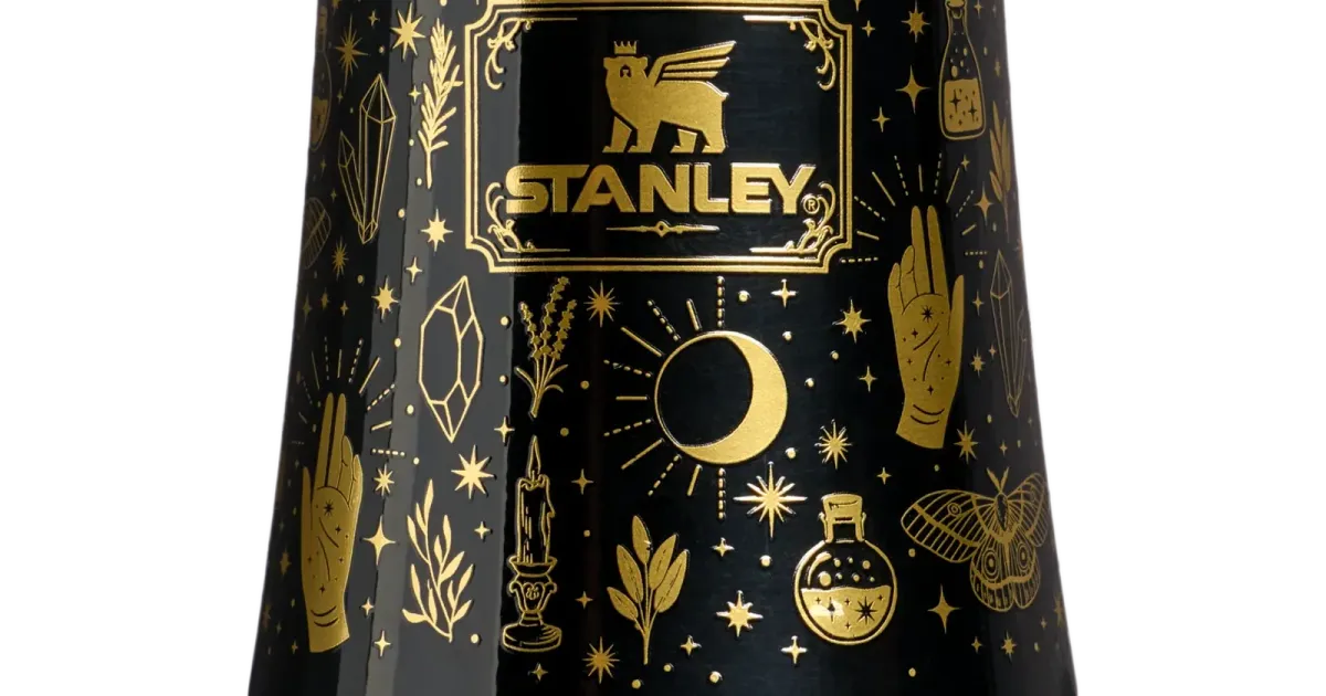 Stanley drinkware close-up with gold print on a black bottle