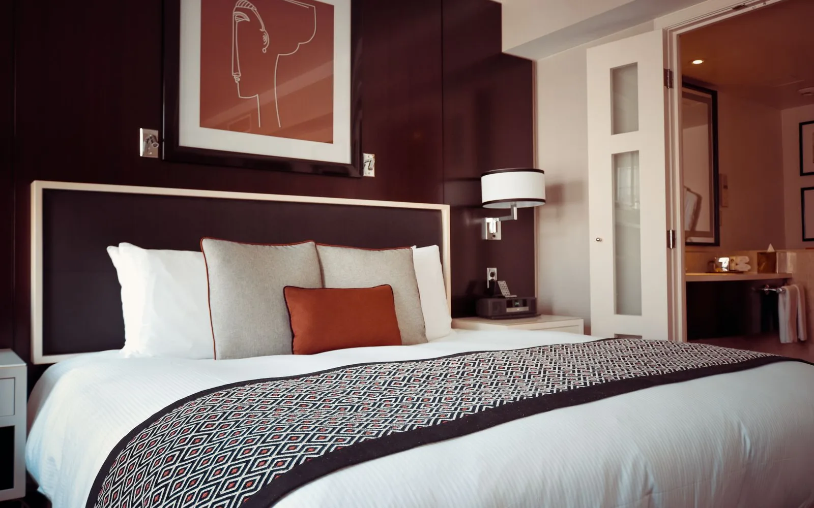 Hotel-style made bed with white linens