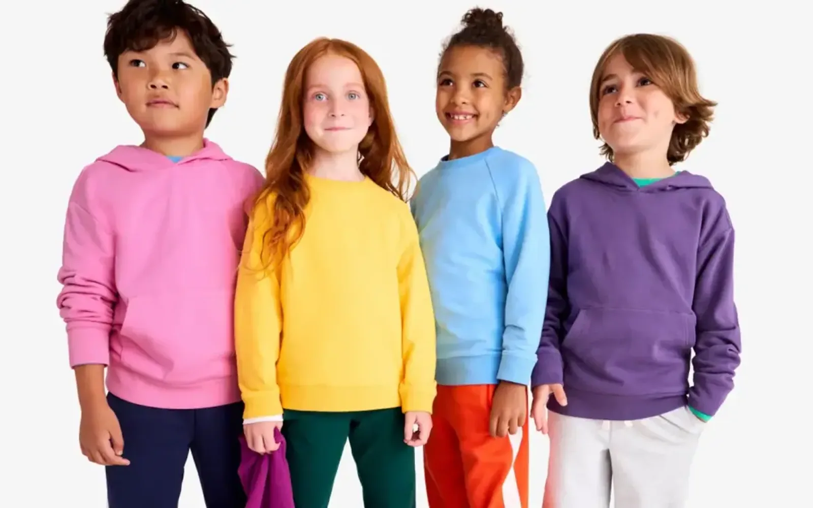 Four kids in solid-color sweatshirts