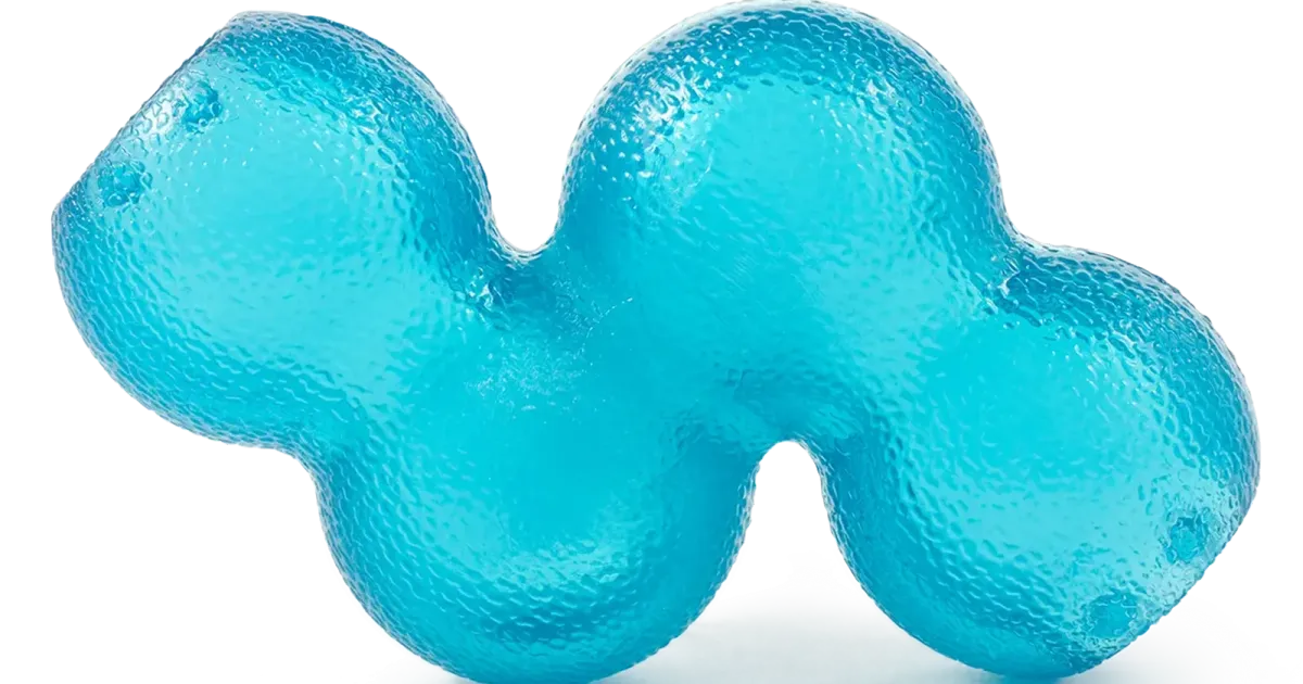 Blue rubber dog toy photographed on a black studio field