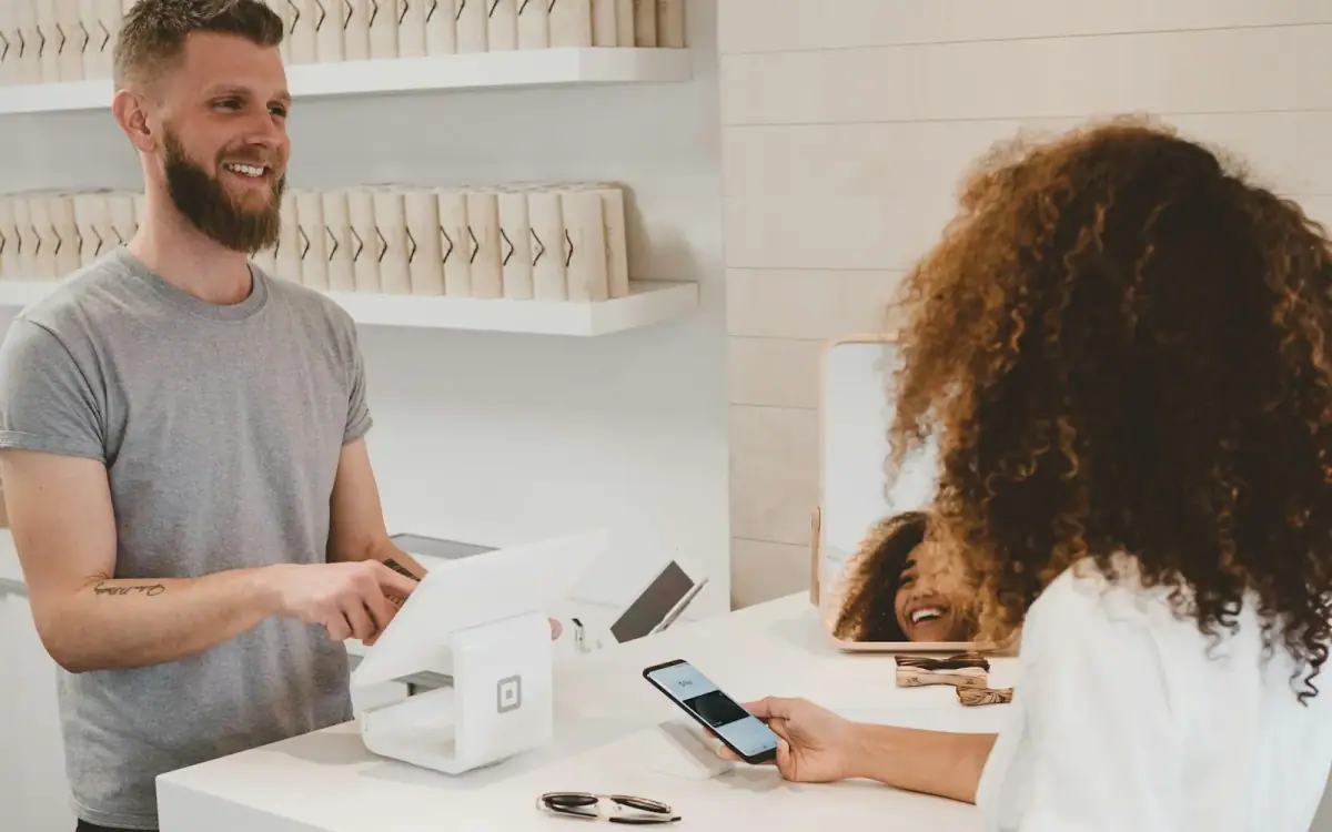 Customer paying at a branded retail checkout counter