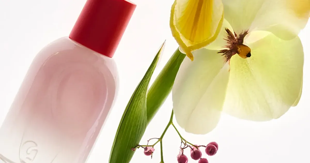 Perfume bottle beside an iris — the catalog a support desk is written for