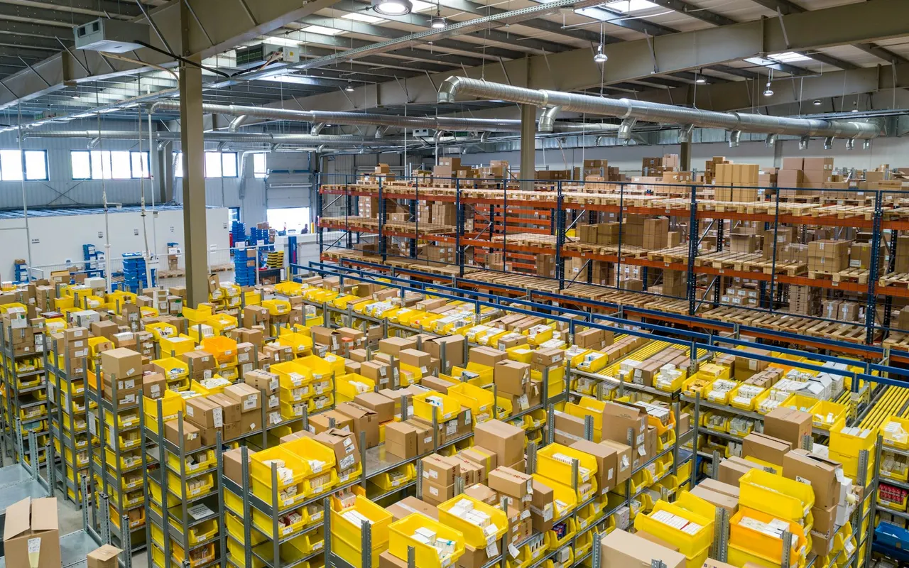Fulfillment warehouse aisles packed with boxes and bins