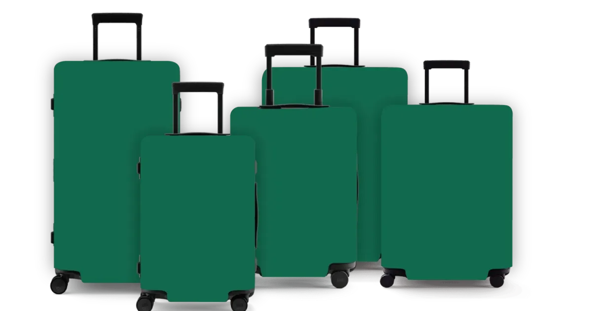 Green hard-shell suitcases photographed as a travel set