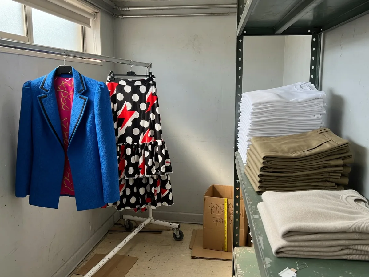 A trend blazer and skirt beside a stack of folded basics